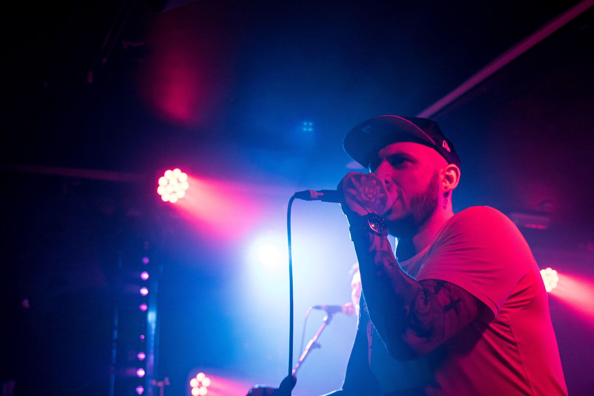 Headshot of Marc singing with a microphone in his hand.