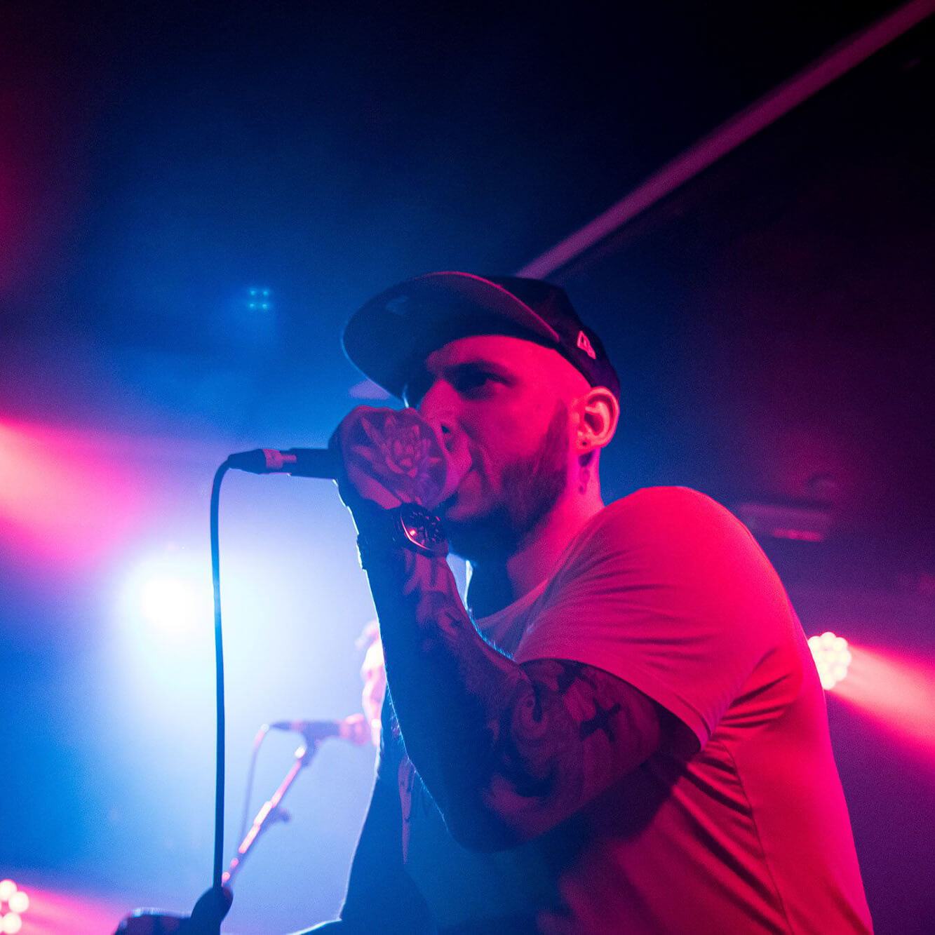 Headshot of Marc singing with a microphone in his hand.